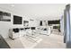 Bright, open-concept living room features plush carpeting, modern decor, and seamless flow into the kitchen at 5318 Truckee St, Denver, CO 80249