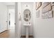 Stylish powder room featuring a pedestal sink, decorative mirror, and modern lighting at 5318 Truckee St, Denver, CO 80249