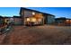 Backyard view showcasing the covered patio and well-maintained lawn at 12863 Crane River Dr, Firestone, CO 80504