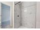 Bright bathroom with a marble-tiled shower and gray walls at 12863 Crane River Dr, Firestone, CO 80504