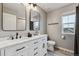 Bright bathroom with a double sink vanity with marble countertops and modern black fixtures at 12863 Crane River Dr, Firestone, CO 80504