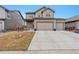 Beautiful home boasting a three-car garage, green lawn, and welcoming front porch for relaxing and entertaining at 12863 Crane River Dr, Firestone, CO 80504