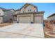 Spacious home featuring a large driveway, well-maintained landscaping, and a three-car garage for ample parking at 12863 Crane River Dr, Firestone, CO 80504