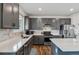 Modern kitchen with grey cabinets, stainless steel appliances, ample counter space, and an island for meal preparation at 12863 Crane River Dr, Firestone, CO 80504