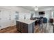 Open concept view of the eat-in kitchen island leading to the stairs and living room at 12863 Crane River Dr, Firestone, CO 80504