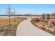 Scenic walking path featuring lake views and playground equipment throughout the community at 12863 Crane River Dr, Firestone, CO 80504