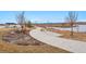 Scenic walking path featuring lake views, and rest seating areas throughout the community at 12863 Crane River Dr, Firestone, CO 80504