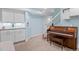 Cozy basement featuring a piano and built-in cabinets for storage at 17826 E 107Th Way, Commerce City, CO 80022