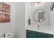 Chic powder room with decorative mirror, marble-like accent wall, and modern vanity at 17826 E 107Th Way, Commerce City, CO 80022