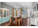 Modern dining room with a long wooden table and hardwood floors at 17826 E 107Th Way, Commerce City, CO 80022