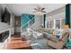 Bright and airy living room featuring a sectional sofa and hardwood floors at 17826 E 107Th Way, Commerce City, CO 80022