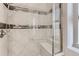 Elegant shower design with stylish tiling, glass enclosure, showerhead and seating at 12213 Joplin St, Commerce City, CO 80603