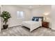 Inviting bedroom with blue accents, a comfortable bed, and natural light from the window at 12213 Joplin St, Commerce City, CO 80603