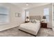 Cozy bedroom with neutral walls, carpet, and a comfortable upholstered bed frame at 12213 Joplin St, Commerce City, CO 80603