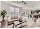 Open concept living room and dining area with large windows and lots of natural light at 12213 Joplin St, Commerce City, CO 80603