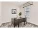 Cozy office space featuring a dark wood desk, neutral-toned chair, and ample natural light at 12213 Joplin St, Commerce City, CO 80603