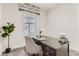 Inviting home office area with a classic wood desk, stylish chair, and decorative window treatment at 12213 Joplin St, Commerce City, CO 80603