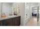 Bright bathroom featuring a shower-tub, dark wood vanity with modern fixtures at 236 Back Nine Dr, Castle Pines, CO 80108