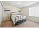 Cozy bedroom features a metal frame bed, plush carpet, and bright natural light from the window at 236 Back Nine Dr, Castle Pines, CO 80108