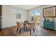 Bright dining area features a glass table, modern decor, and sliding glass door to the backyard at 236 Back Nine Dr, Castle Pines, CO 80108