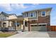 Inviting two-story home with a stone facade, covered porch, and well-maintained lawn at 236 Back Nine Dr, Castle Pines, CO 80108