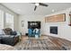 Comfortable living room featuring a fireplace, TV, and an open layout at 236 Back Nine Dr, Castle Pines, CO 80108