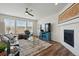 Cozy living room featuring a tiled fireplace, hardwood floors, and modern decor at 236 Back Nine Dr, Castle Pines, CO 80108