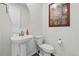 Cozy powder room with pedestal sink, modern fixtures, and neutral color palette at 236 Back Nine Dr, Castle Pines, CO 80108