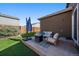 Cozy backyard space with artificial turf, concrete patio area with comfortable seating, and a sleek fire pit at 1772 Taos St, Brighton, CO 80603