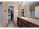 Bathroom with an expansive cabinet, large mirror, and walk-in closet at 1772 Taos St, Brighton, CO 80603