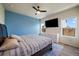 Comfortable bedroom with modern ceiling fan, large window, and blue accent wall at 1772 Taos St, Brighton, CO 80603