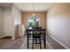 Dining room with hardwood floors, modern light fixture, and a view into the front yard at 1772 Taos St, Brighton, CO 80603