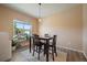 Bright dining area with wood floors, a modern light fixture, and a large window with a view at 1772 Taos St, Brighton, CO 80603