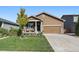 Inviting home featuring a well-manicured lawn and a charming front porch with seating at 1772 Taos St, Brighton, CO 80603