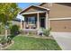 Charming front porch featuring seating and a meticulously landscaped yard with colorful flowers at 1772 Taos St, Brighton, CO 80603