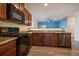 Kitchen featuring stainless steel appliances, wood cabinets, and a view into the living room at 1772 Taos St, Brighton, CO 80603