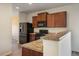 Kitchen featuring stainless steel appliances, wood cabinets, and a functional breakfast bar at 1772 Taos St, Brighton, CO 80603