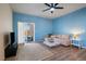 Bright living room featuring hardwood floors, a comfortable sofa, and sliding glass doors to the patio at 1772 Taos St, Brighton, CO 80603