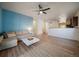Open living room featuring new wood flooring, modern ceiling fan, and easy access to kitchen at 1772 Taos St, Brighton, CO 80603