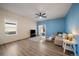 Spacious living room featuring ample natural light, wood floors, and a sliding glass door to the backyard at 1772 Taos St, Brighton, CO 80603