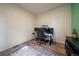 Office space with natural light, featuring a desk with multiple monitors, situated on wood floors with stylish area rug at 1772 Taos St, Brighton, CO 80603