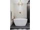 Modern bathroom features a freestanding soaking tub and contemporary chandelier at 1919 W 32Nd Ave, Denver, CO 80211