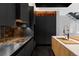Contemporary kitchen features stainless steel appliances, dark cabinetry, and a wood-accented island with countertop at 1919 W 32Nd Ave, Denver, CO 80211