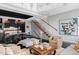 Open-concept living space with modern furnishings, an open staircase, and a sleek kitchen in the background at 1919 W 32Nd Ave, Denver, CO 80211
