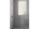 Stylish shower with neutral tile, a glass block window and modern fixtures at 1919 W 32Nd Ave, Denver, CO 80211