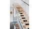 Elegant glass and wood staircase with modern design, creating a bright and open transition between levels at 1919 W 32Nd Ave, Denver, CO 80211