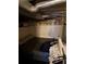 Unfinished basement with exposed pipes and stone foundation, featuring a small living area at 215 Colorado Blvd, Idaho Springs, CO 80452
