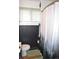 Bathroom with wood paneling and a stylish forest-themed shower curtain at 215 Colorado Blvd, Idaho Springs, CO 80452