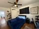 Comfortable bedroom featuring a ceiling fan, dark furniture, and a cozy blue comforter at 215 Colorado Blvd, Idaho Springs, CO 80452