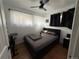 Bright bedroom featuring a ceiling fan, cozy bed, and natural light through sheer curtains at 215 Colorado Blvd, Idaho Springs, CO 80452